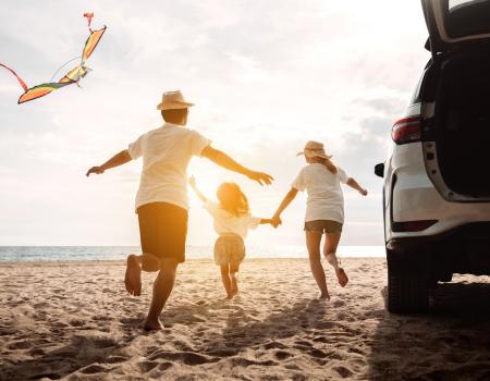 family at beach after road trip