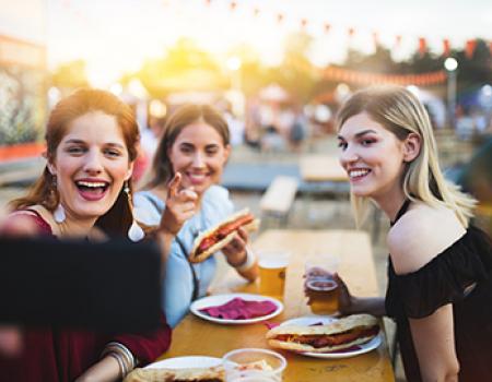 Girlfriends at a German Sausage Festival