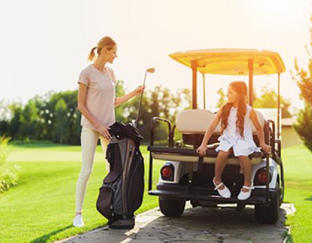 Mother golfing with daughter