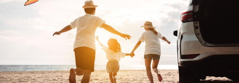 family at beach after road trip