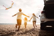 family at beach after road trip