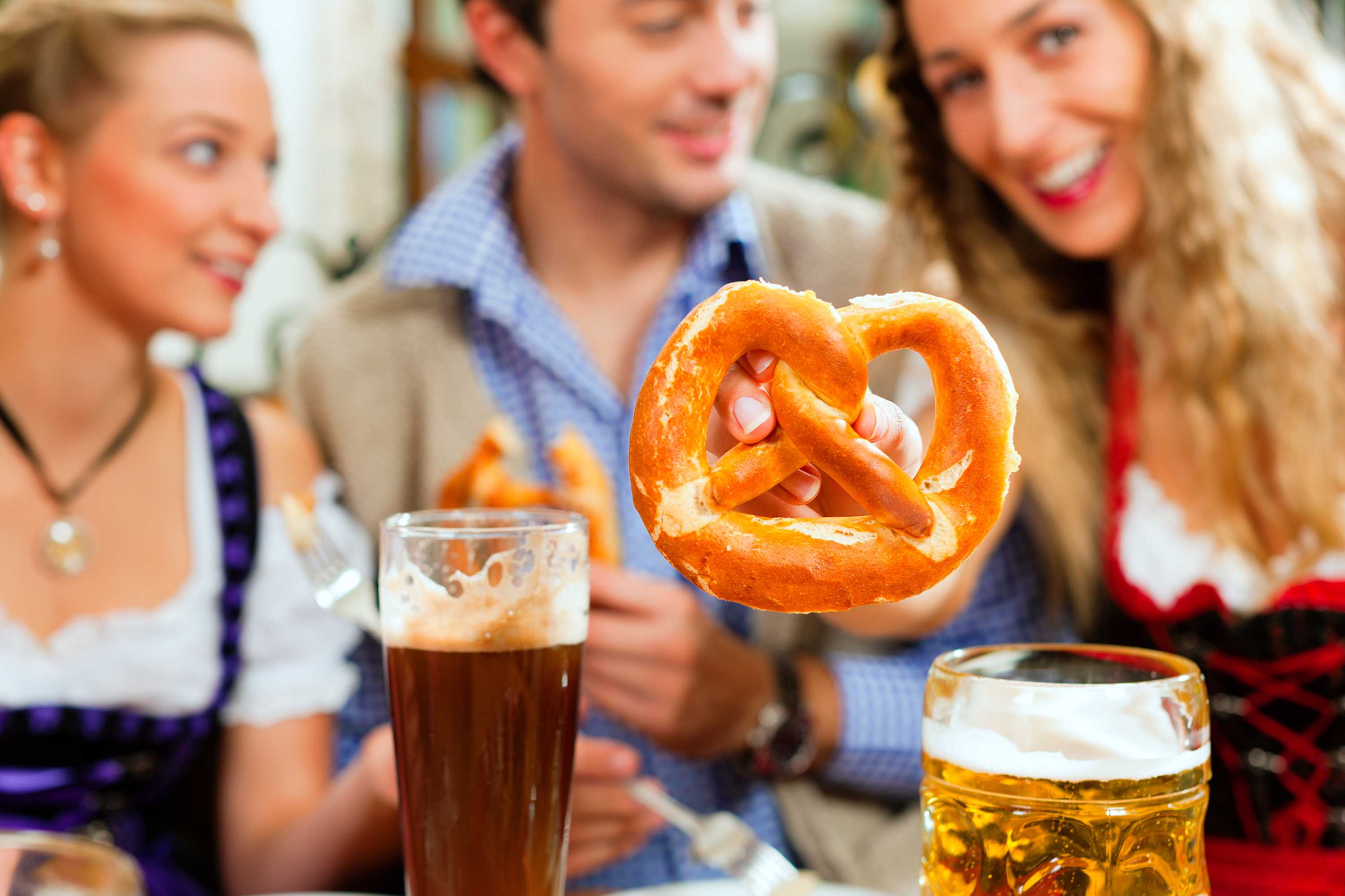 Friends at a German Festival with Beer & Soft Pretzels 